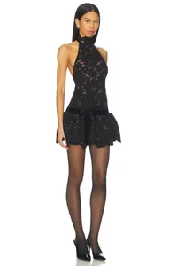Elegant detail view of a black lace halter mini dress featuring a velvet bow and eyelash hem.