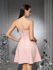 Back view of a pink strapless A-line cocktail dress with invisible zipper