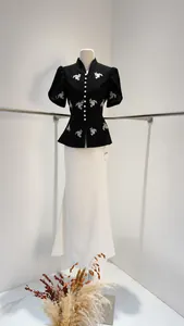 Detailed view of the black puff sleeve top and white mermaid skirt on a mannequin