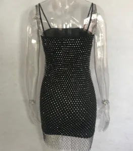 Detailed view of a sexy black mini dress featuring a sparkling rhinestone mesh overlay.