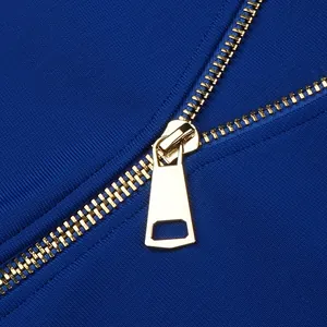 Detailed macro view of a high-quality gold metal zipper on a royal blue bodycon bandage dress.