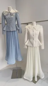 Detail view of French style peplum suit with elegant floral lace collar and pleated skirt