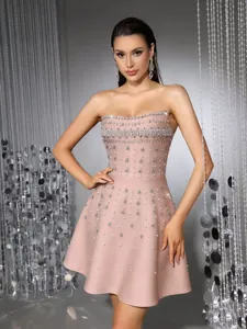 Detail view of strapless pink evening dress with intricate hand-sewn rhinestone embellishments