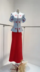 Detailed view of light blue floral puff sleeve top and long red skirt two-piece set