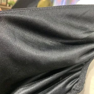 Close-up detail of black shimmering elastic fabric with fine micro-ribbed texture