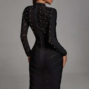 Elegant black bandage dress with heavy stud detailing and sheer mesh long sleeves