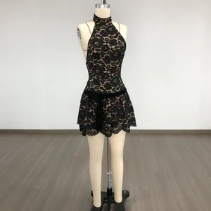 Detail view of a black lace halter mini dress with velvet bow and eyelash lace trim.