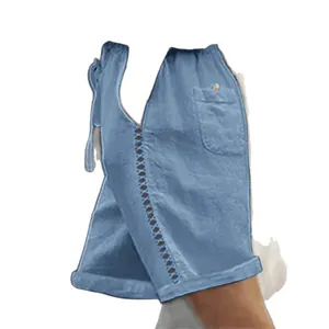 Casual blue women's knee-length shorts with delicate lace hollow stitching on the side.