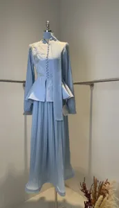Elegant light blue pleated skirt set featuring floral mesh sleeves and peplum top.