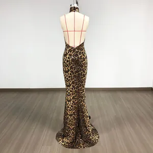 Back view of a halter neck sequined leopard print dress with a deep open back design