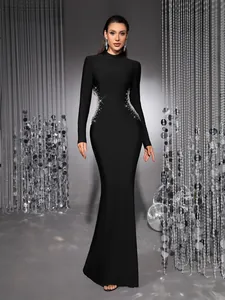 Full view of elegant black long-sleeved evening dress with sparkling rhinestone waist