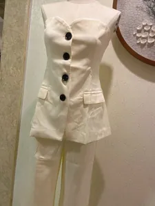 Elegant white two-piece set with strapless button-down top and wide-leg trousers