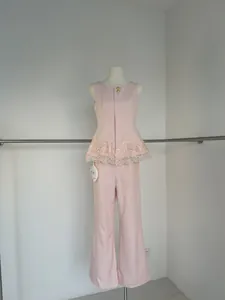 Elegant pink sleeveless lace peplum top and wide-leg trousers two-piece set