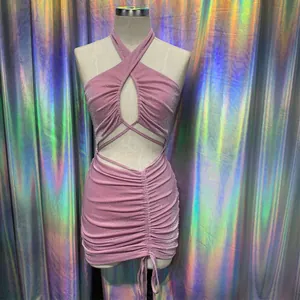 Detailed shot of the pink shimmering fabric and ruching on a halter mini dress