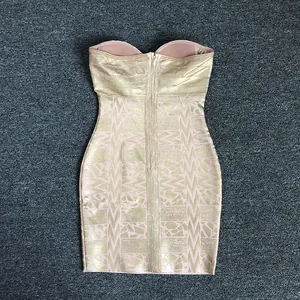 Detail view of the back of a luxury gold bronzing strapless bandage mini dress.