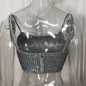 Detail view of silver sequined cropped top with chain straps and back zipper closure.