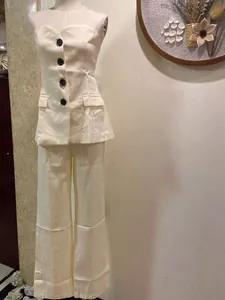 Elegant ivory strapless vest and wide-leg trousers two-piece set shown on mannequin
