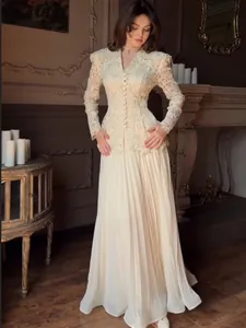 Elegant ivory lace two-piece set with long sleeve buttoned top and pleated skirt