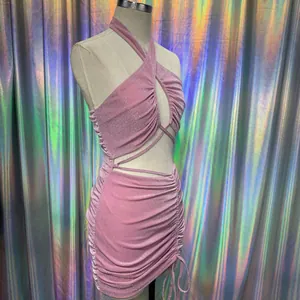 Side view detail of pink glittery halter dress with ruched and cutout design on mannequin