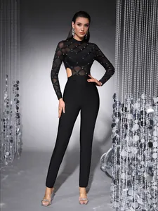 Elegant black mesh long sleeve jumpsuit featuring hand-studded beads and cutout waist details
