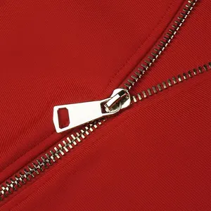 Close-up of gold metal zipper detail on a red high-elastic bandage party dress.