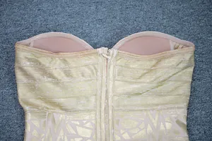 Close-up of champagne gold foil bandage dress showing back zipper and lining.