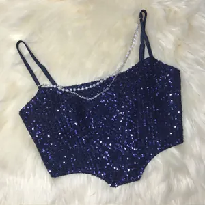 Detailed view of navy sequined crop top with pearl and chain strap detail