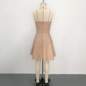 Rear view detail of a nude bandage mini dress with side pearls on a tailor's mannequin