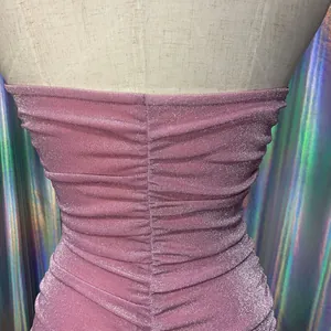 Close-up detail of shimmering pink ruched fabric texture on a slim-fit halter backless dress