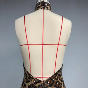 Detailed back view of a backless leopard print sequin halter dress on a mannequin