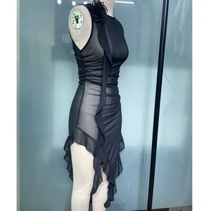 Detail view showing the black sleeveless sheer mesh dress featuring irregular ruffled hem