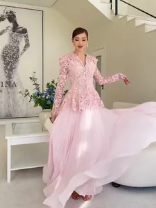 Elegant pink lace two-piece set with long sleeves and a flowy pleated maxi skirt for women