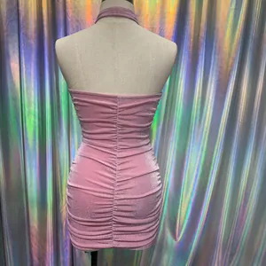 Close-up detail of the back of a pink glittery ruched halter neck bodycon mini dress