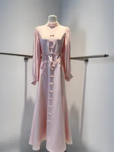 Elegant pink French lace dress with long mesh sleeves and floral embroidery detail.