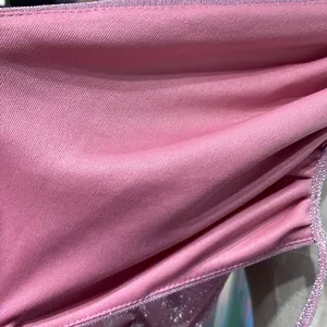 Close-up detail showing the soft texture and fine mesh fabric of the pink ruched dress.
