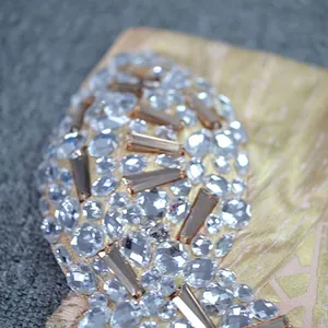 Detailed macro view of sparkling clear rhinestones on luxury gold bandage dress material