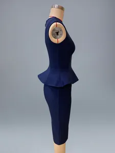 Side view showing the peplum detail and silhouette of the blue two-piece bandage set.