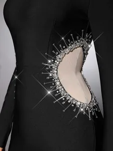 Close-up of sparkling rhinestone and mesh detail on black bandage party evening dress