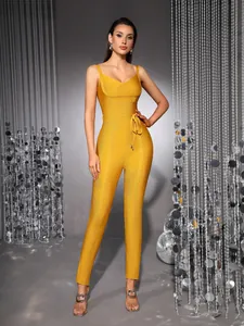 Detailed view of a stunning yellow bandage jumpsuit with v-neck and waist tie on a model