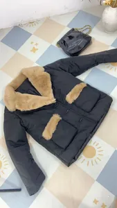 Elegant black winter jacket with plush beige faux fur collar and pocket trim detail
