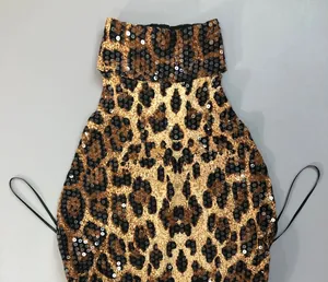 Detailed close-up showing the leopard print and shimmering sequins on this halter neck dress