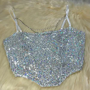 Detail showing the silver holographic sequins and pearl chain straps of this camisole top.