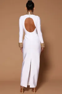 Back view of white bandage maxi dress with gold beaded collar and cuffs, open back