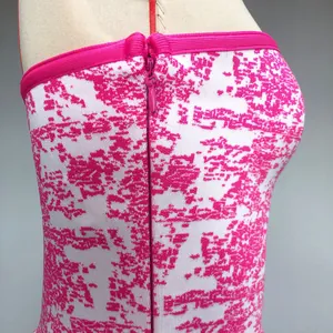 Detailed side view of pink and white jacquard bandage tube top featuring hidden zipper closure