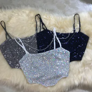 Detailed view of sequined chain strap crop tops in silver, navy, and white iridescent
