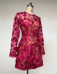 Detail view of magenta 3D floral embroidery lace on an elegant long-sleeved mini dress