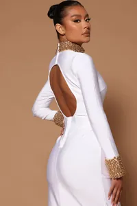 Professional detail view of white backless bandage dress with gold beaded collar and cuffs
