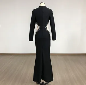 Back view of black evening gown featuring rhinestone embellishments and mesh cut-outs