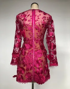 Back view of fuchsia long sleeve dress with 3D floral embroidery and full length zipper
