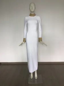Detailed view of elegant white bandage dress with gold beaded collar and cuffs